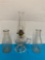 Clear glass oil lamp and two milk bottles