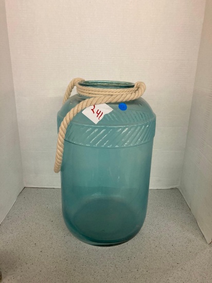 water jug 17 inches tall glass cylinder filled with Easter eggs 24 inches tall