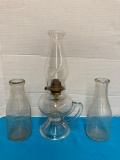 Clear glass oil lamp and two milk bottles