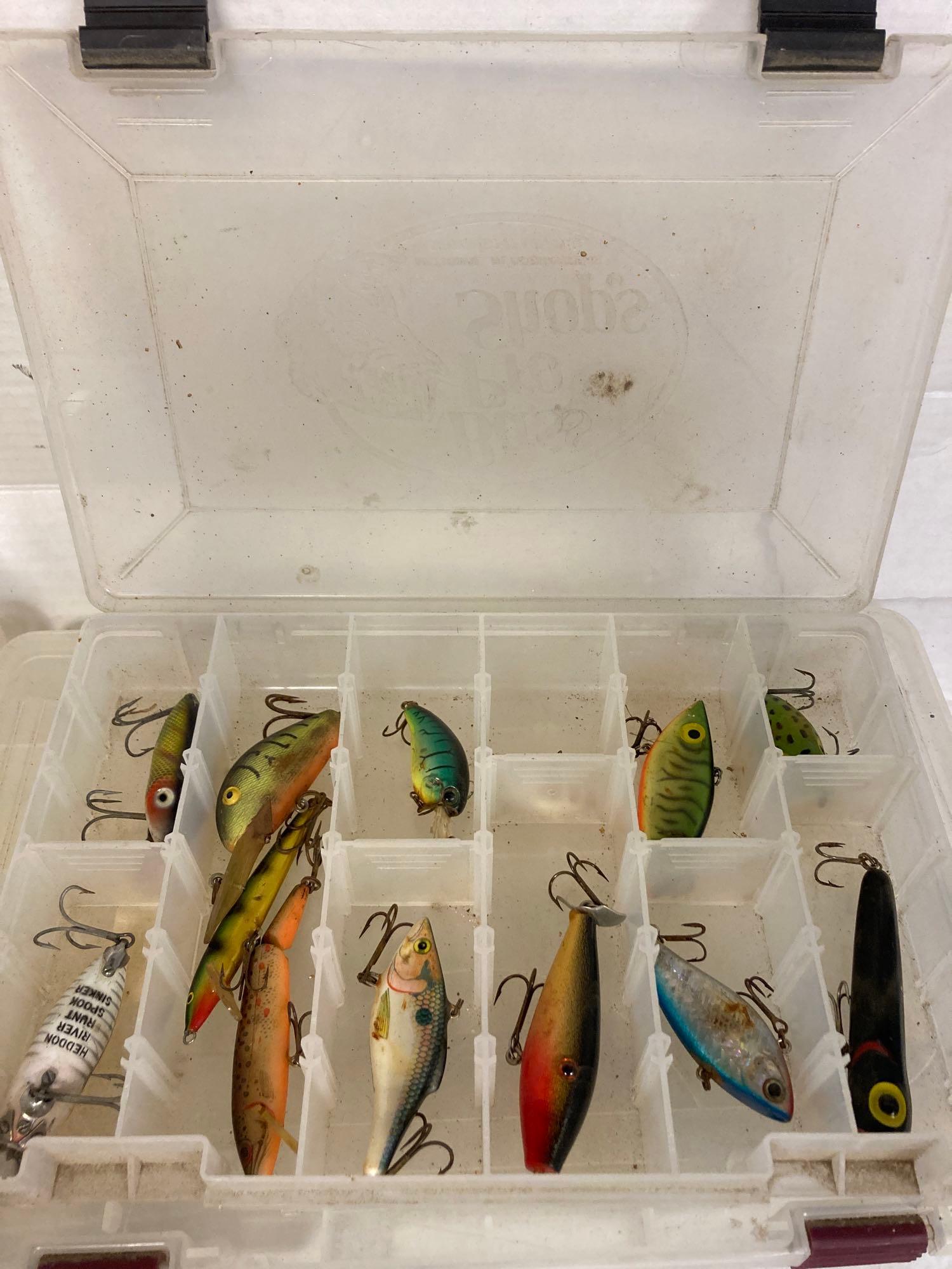 4 tackle boxes one with lures and 3 reels