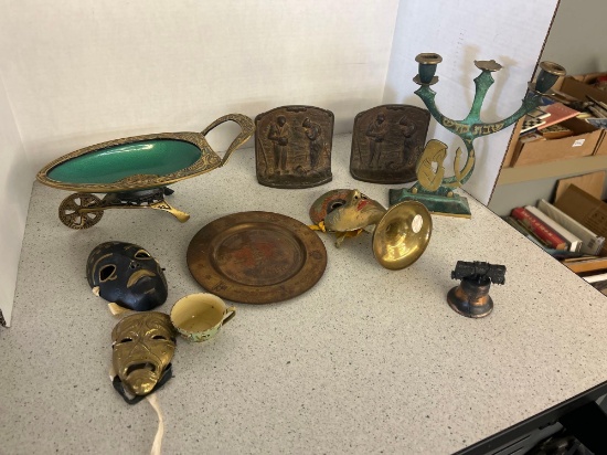 vintage metal masks, plate, bell, candle stand, wheelbarrow and cast iron praying decor