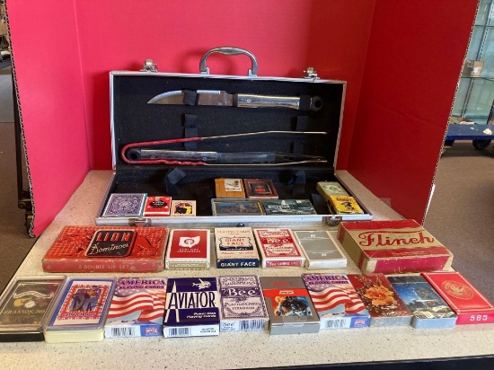 25 sets of playing cards and a partial grilling set