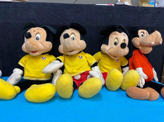 Three Mickey Mouse dolls and a goofy Cassette player dolls