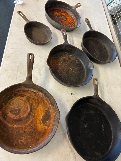 five cast-iron Frying pans