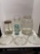 Glass butter churn, two other large glass jars, Blue jar and three glass pot lids