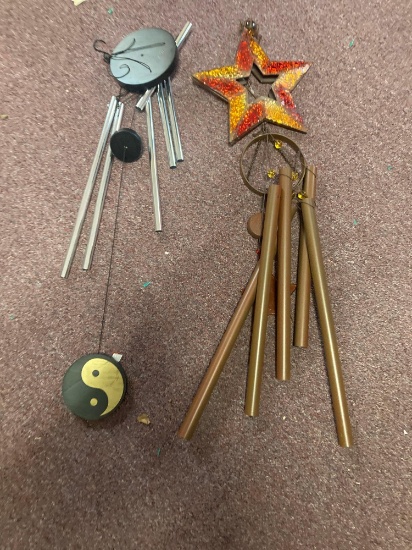 Two windchimes and a basket that could be used for a planter