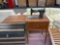 White rotary Sewing machine in cabinet