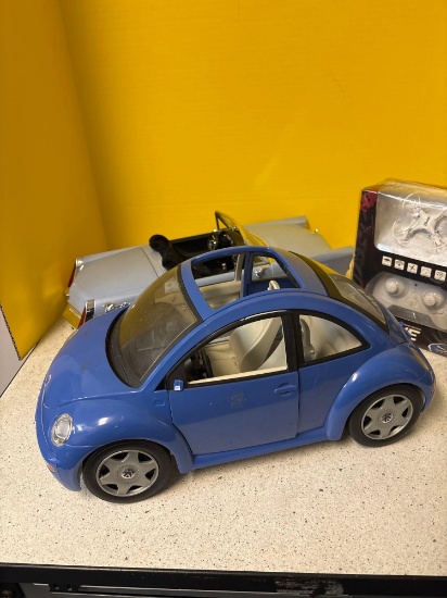 Two toy cars, and a mini drone