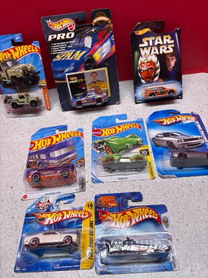 Eight hot wheel cars in packages