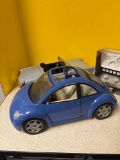 Two toy cars, and a mini drone