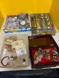 Two childrens tea sets, a silverware set, and jewelry