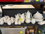 Shelf full of white dishes, Two different patterns