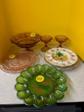 Egg plates, including green carnival glass, amber Glassware