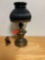 Small brass hurricane lamp with green glass shade