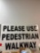 Please use pedestrian walkway, metal sign