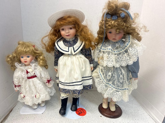 3 collectible dolls on stands