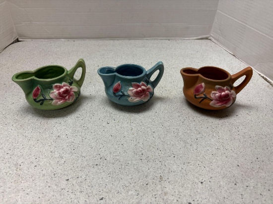 Three Roseville pottery creamers