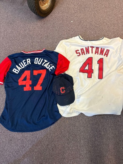2 Cleveland Indians jerseys and a hat