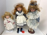 3 collectible dolls on stands