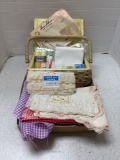 Sewing basket with items inside, fabric, lace, trim, etc.