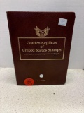 Golden replicas of United States, stamps, and album
