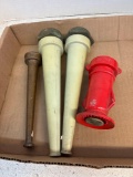 Four vintage nozzles, including a brass one