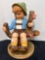 Little boy sitting on a tree stump 20 inches tall