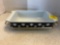 vintage Pyrex black and snowflake rectangular dish on metal stand