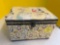 sewing basket with fabric covering of 1950s housewives and household items