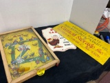 antique tabletop pinball game and cardboard signs
