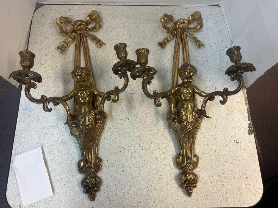 pair of metal wall sconces with cherubs
