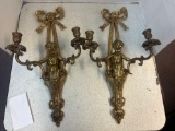 pair of metal wall sconces with cherubs