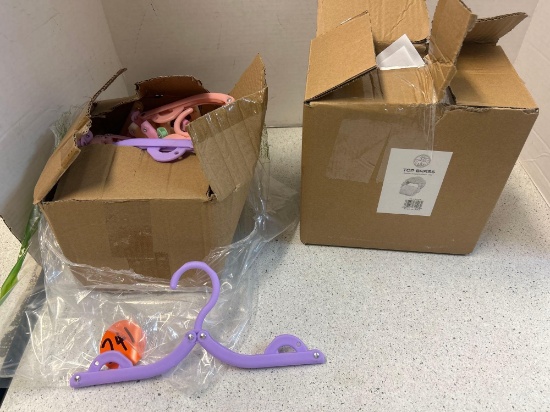 box of folding hangers and crab toilet paper holder