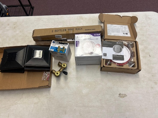 smoke and carbon monoxide alarms, washing machine valves, eight bottle wine rack, and solar lights