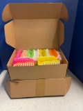 Two boxes of colorful, scrub brushes