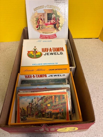 Two cigar boxes of vintage travel postcards