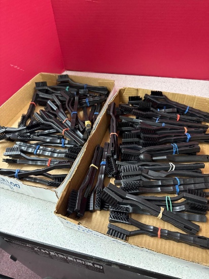 two boxes of black cleaning brushes