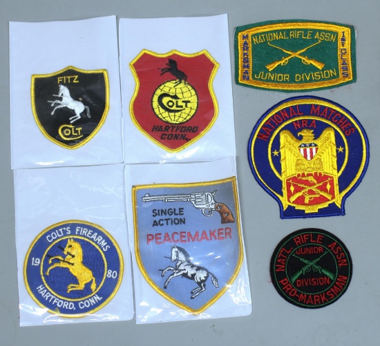 Four Different Colt Firearms Shoulder Patches and Three National Rifle Assn. (NRA) Marksman Patches.