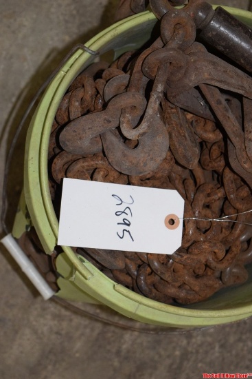 bucket of heavy dutty equipment tie down chains and ratchet