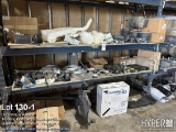 Truck parts on pallet rack including washer fluid containers, hose , air bags , shocks , hangers , f