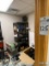 Room: assorted electronics, PC, speakers, printers, 2 shelf units, vacuum