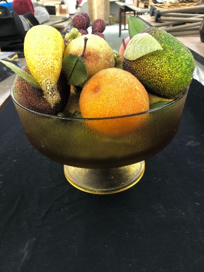 Citrine colored glass fruit bowl with fruit.