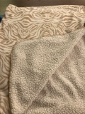 Tan and white throw blanket
