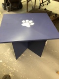 Blue wooden table with white tiger paw