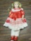 Porcelain doll with red dress