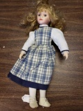 Porcelain doll with blue dress/ white dress