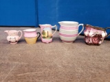 5 small pitchers