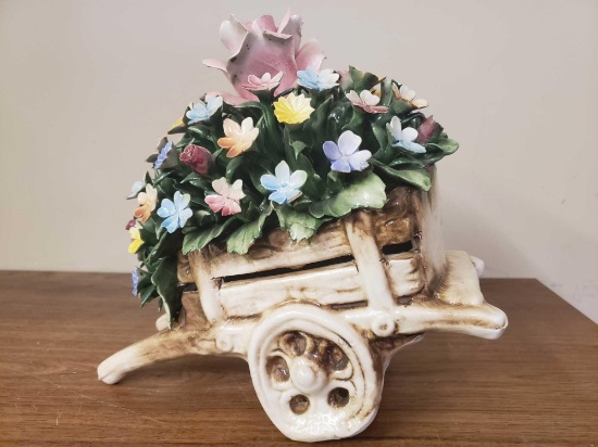 Ceramic wheel barrel with flowers inside