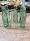 coke bottles and oil container