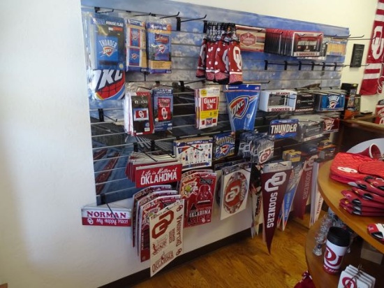 BANNERS ON WALL 12 PCS, LICENSE PLATES & HOLDERS 100+, PENNANTS 90+, KOOZIES 9. FLAGS 21,